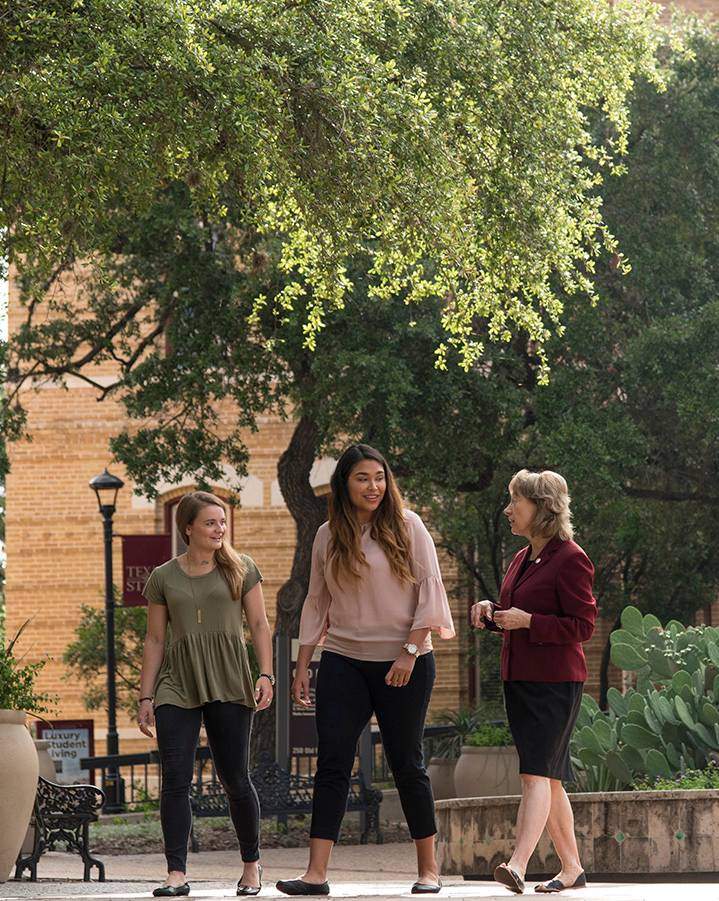 president and students walking near old main