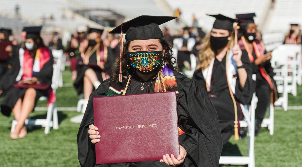 female graduate holding degree during commencement