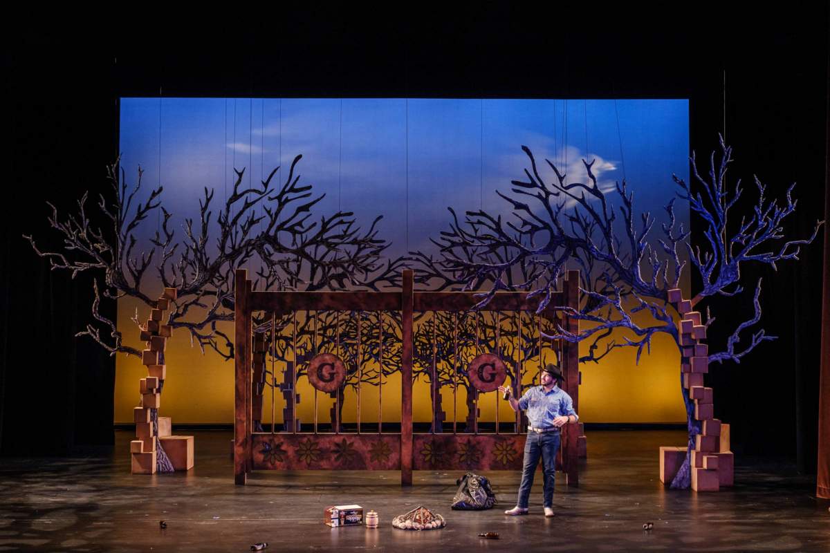 An actor on stage in El Nogalar at Texas State University