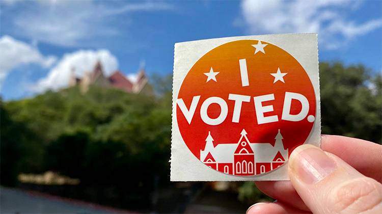 hand holding a vote campaign sticker