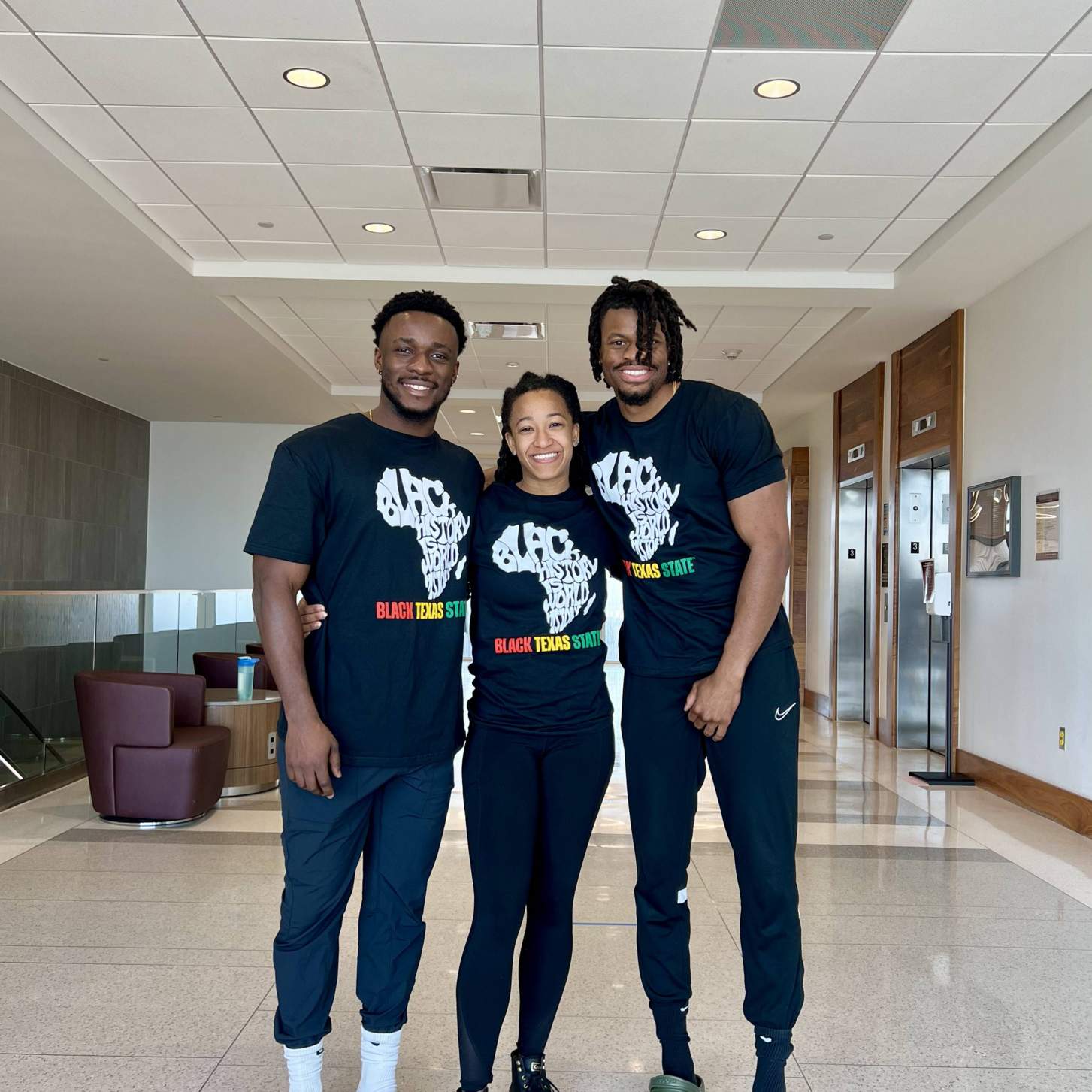 two physical therapy students wearing black history month shirts
