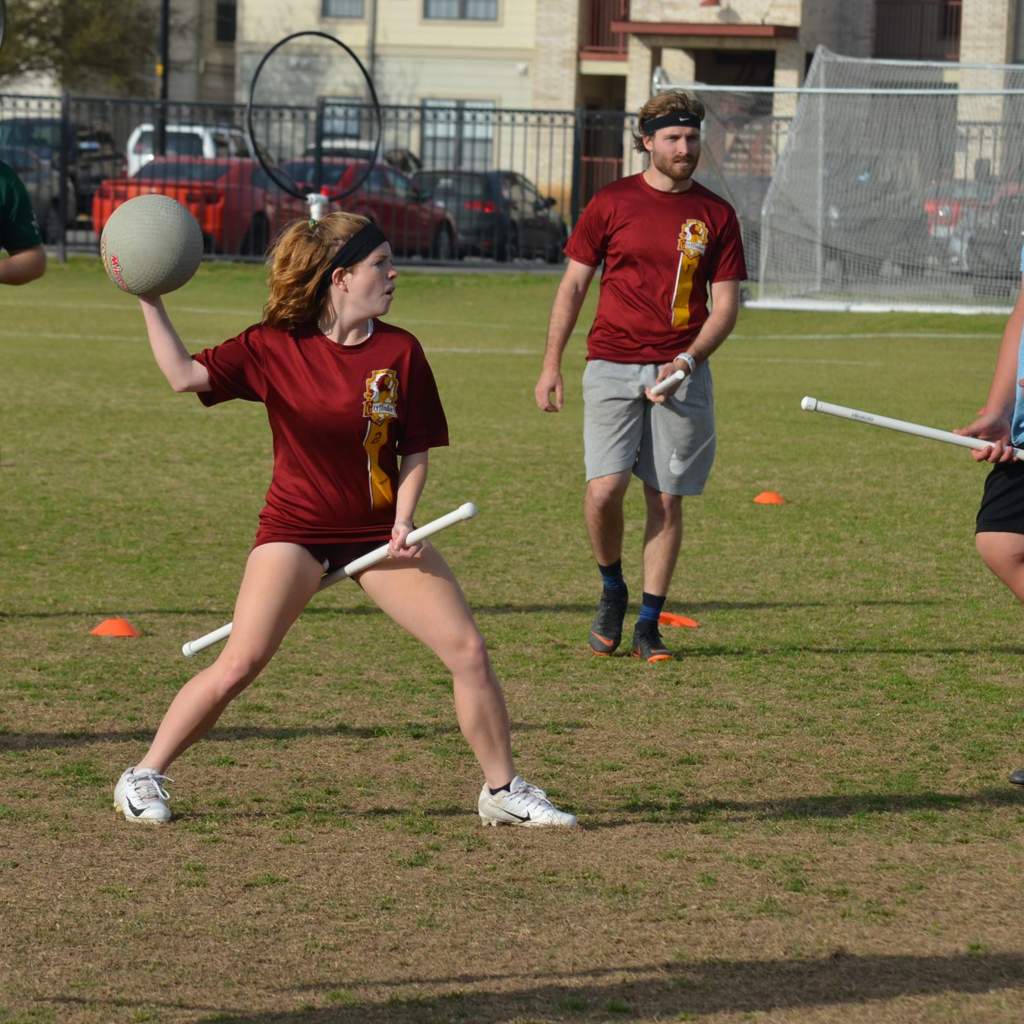 Quidditch player attempting to hit player with ball (bludger).