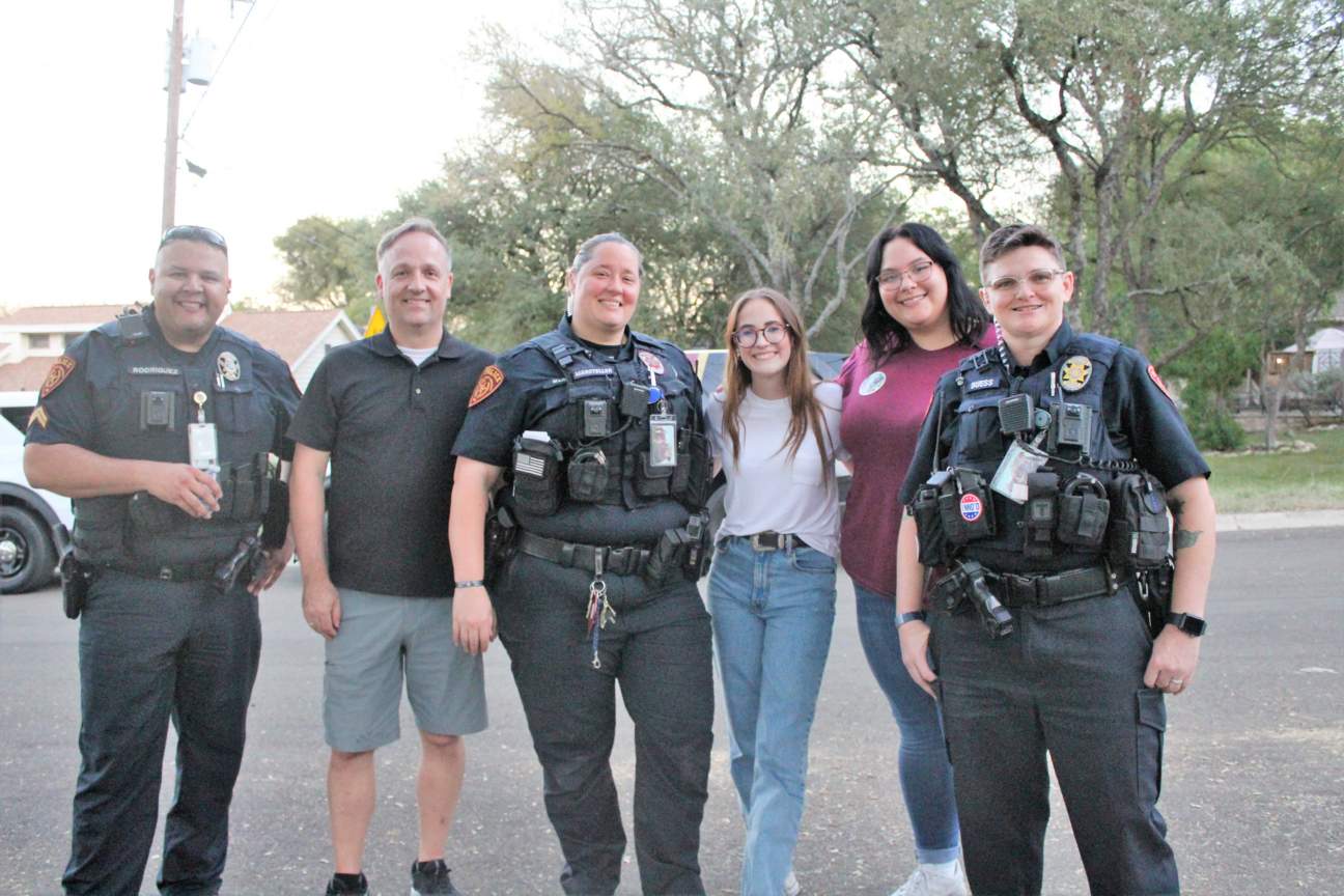 Cpl Rodriguez, VP Algoe, MHO Marsteller, student workers, and Ofc. Buess at NNO.