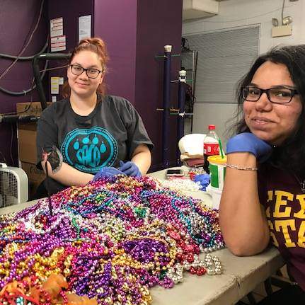 students sorting mardi gras beads