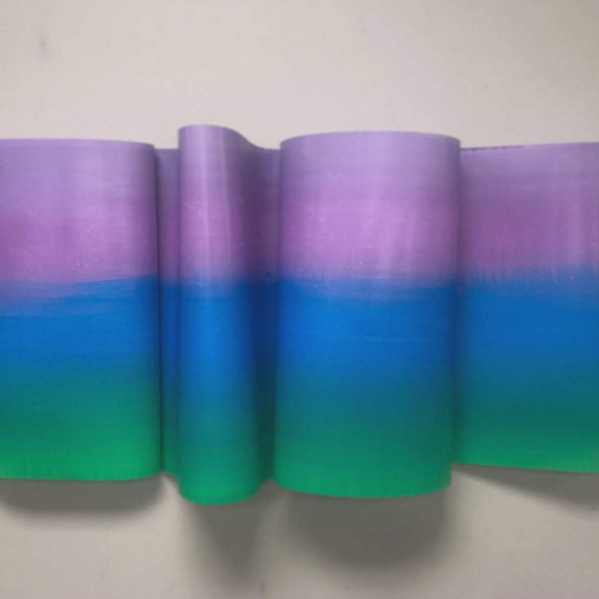 Student work: folded dimensional wall work with gradation of green, blue and purple