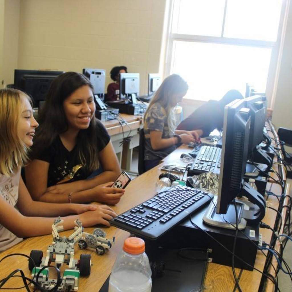 Middle school participants learning how to program their LEGO robot during summer camp. 