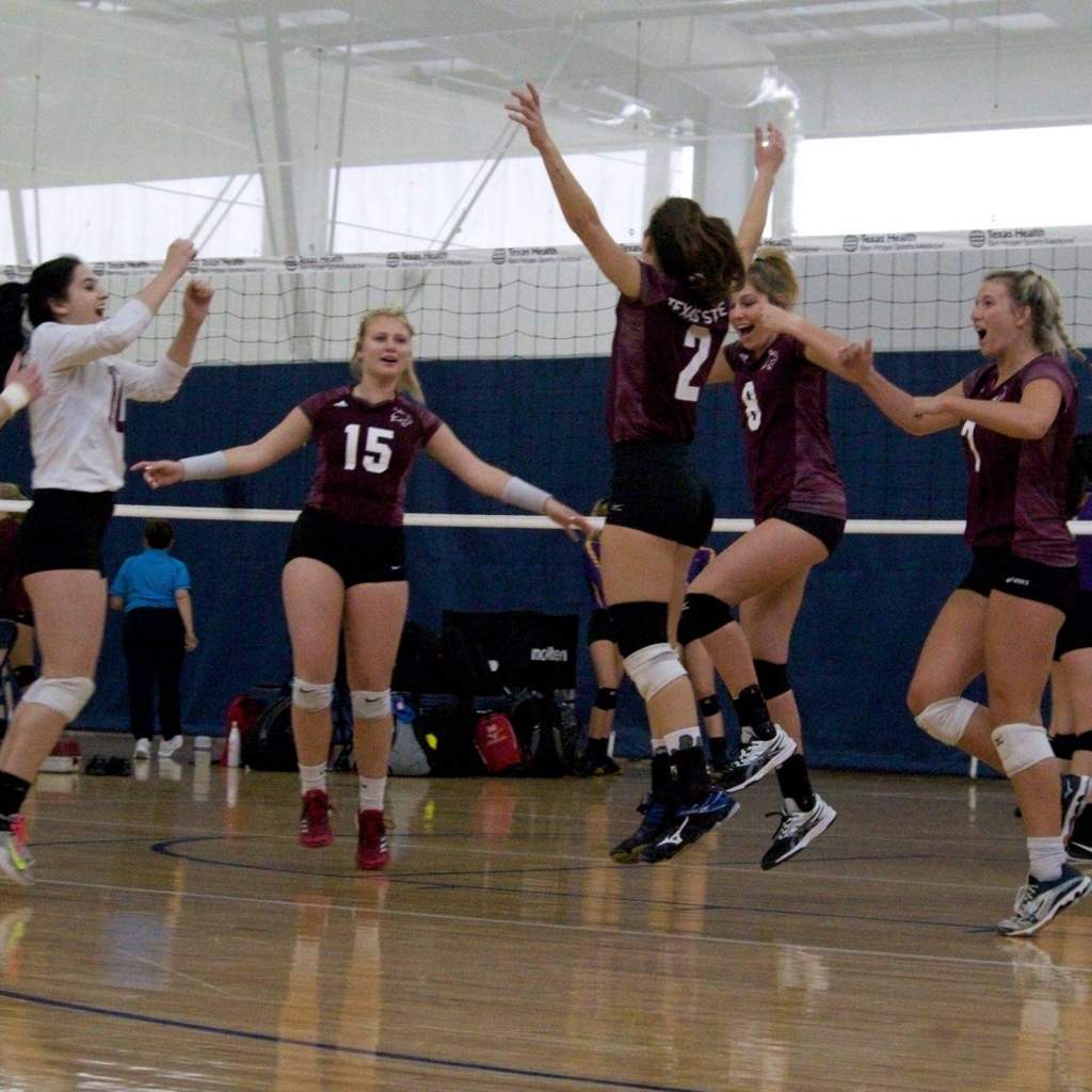 Women's Volleyball club celebrates on court