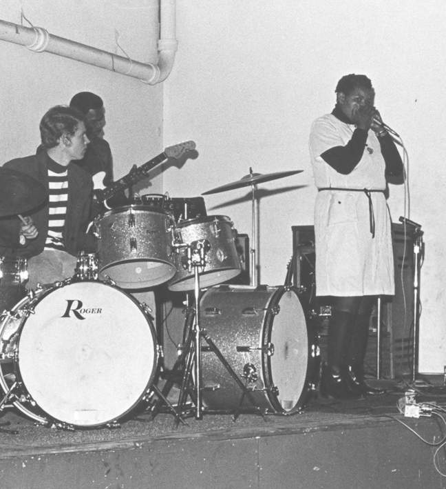 black and white photo of musicians performing on stage