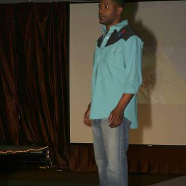 Student wearing coyboy shirt, jeans and boots at the fashion show.