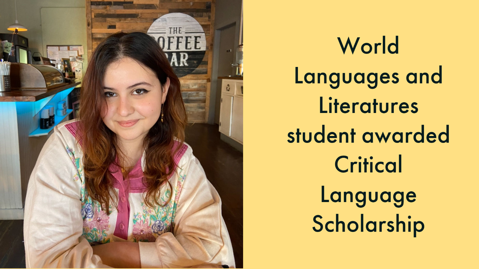 woman with brownish-red hair sitting in a coffee shop, text: World Languages and Literatures student awarded Critical Language Scholarship