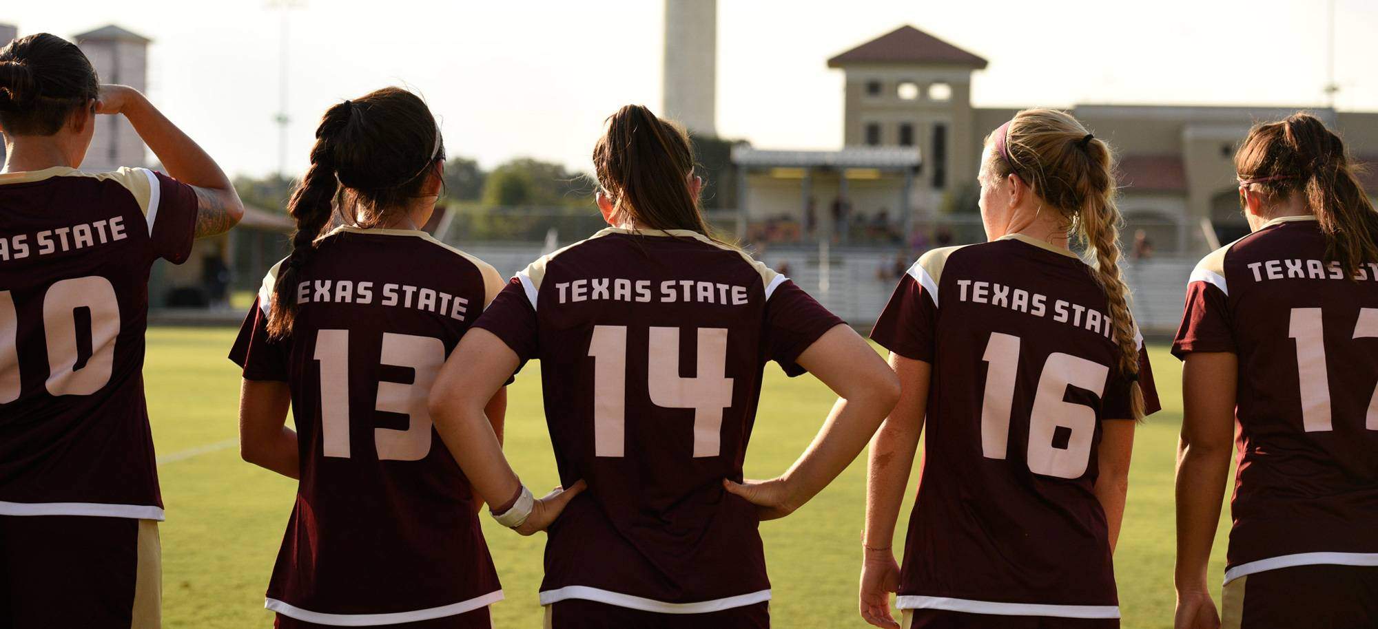 Five femal soccer player wearing jerseys with the numbers 10, 13, 14, 16, 17 on back of jersey.