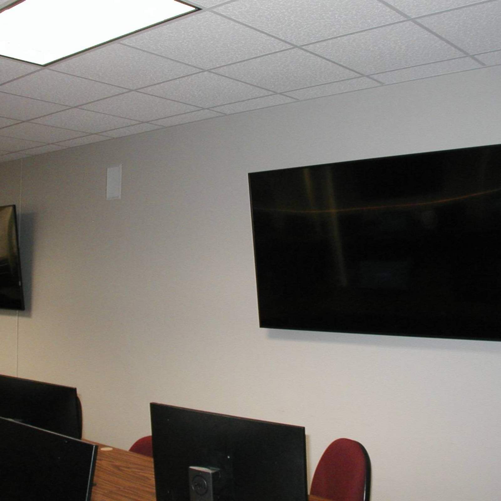 72 inch monitors on walls in classroom.