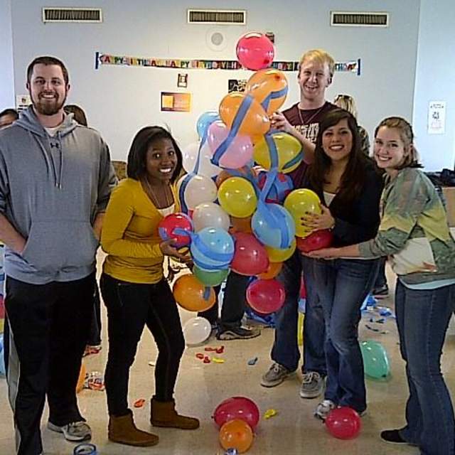 SAHE students participating in a team building activity involving balloons