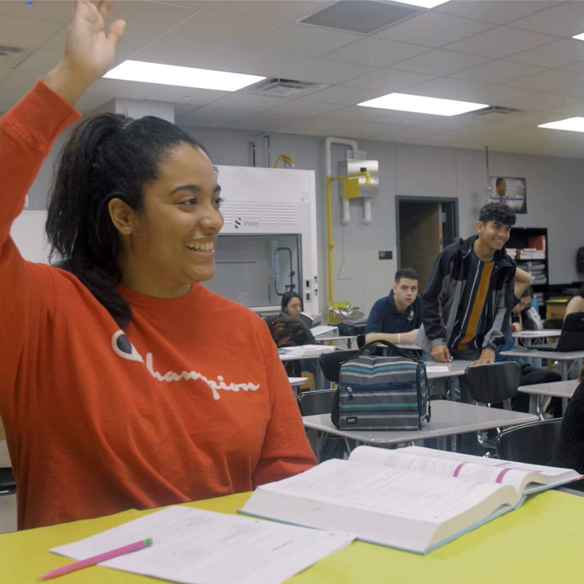 female student raising her hand in class