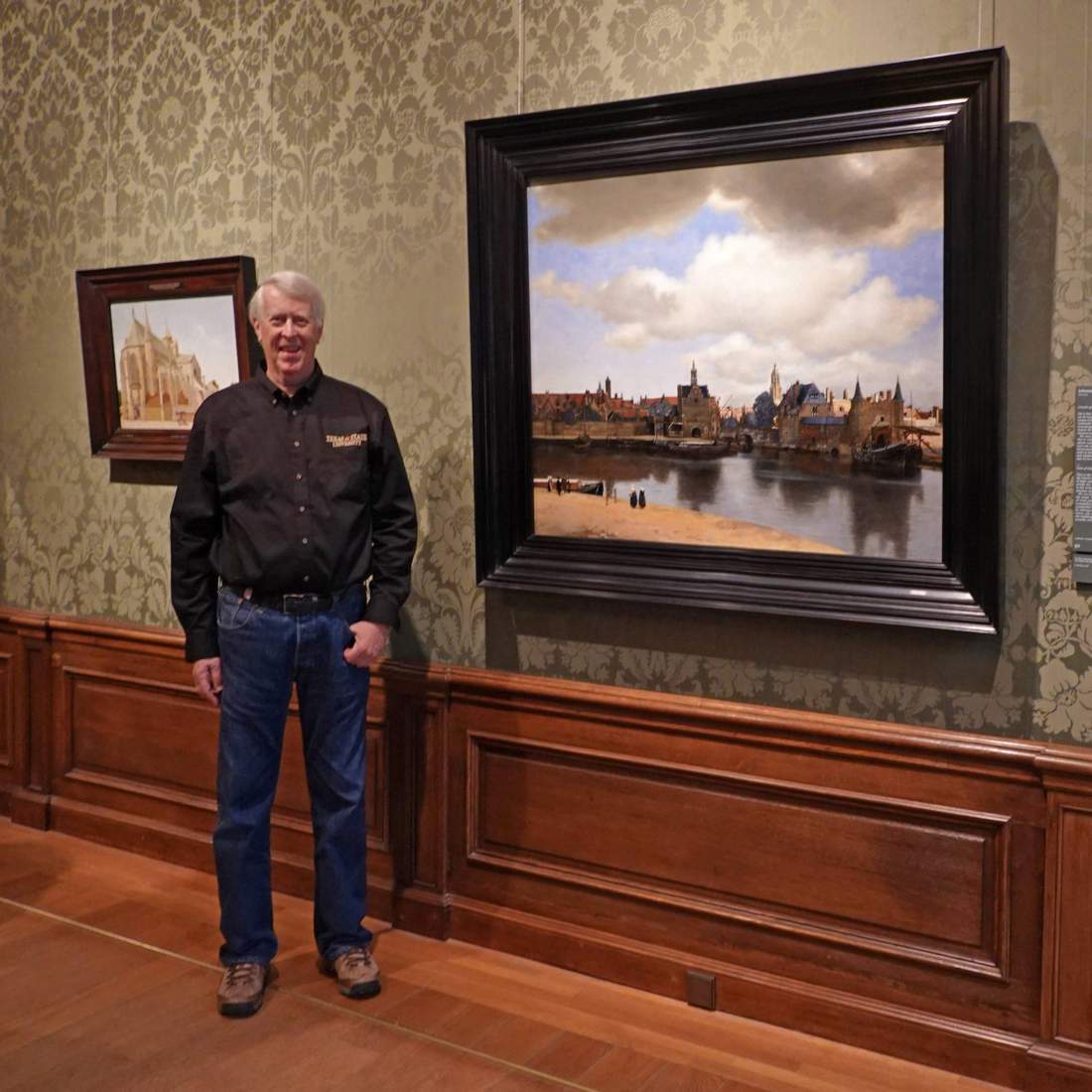 olson standing next to a picture 