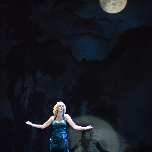 Lady singing under a moon