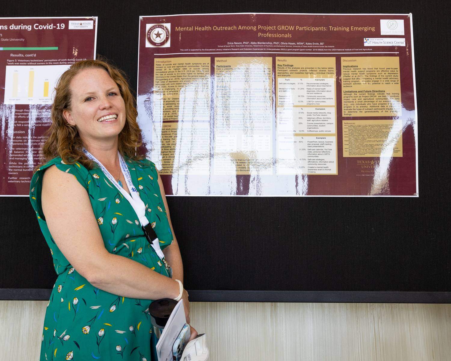 Faculty member standing in front of their research poster at Health Scholar Showcase 2022