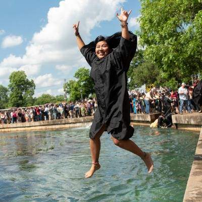 Graduate student jumping into the river