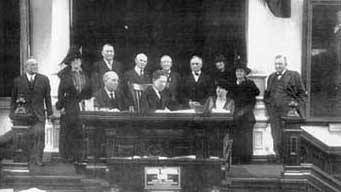 Photo of Gov. W.P. Hobby signing Women's Suffrage Resolution.