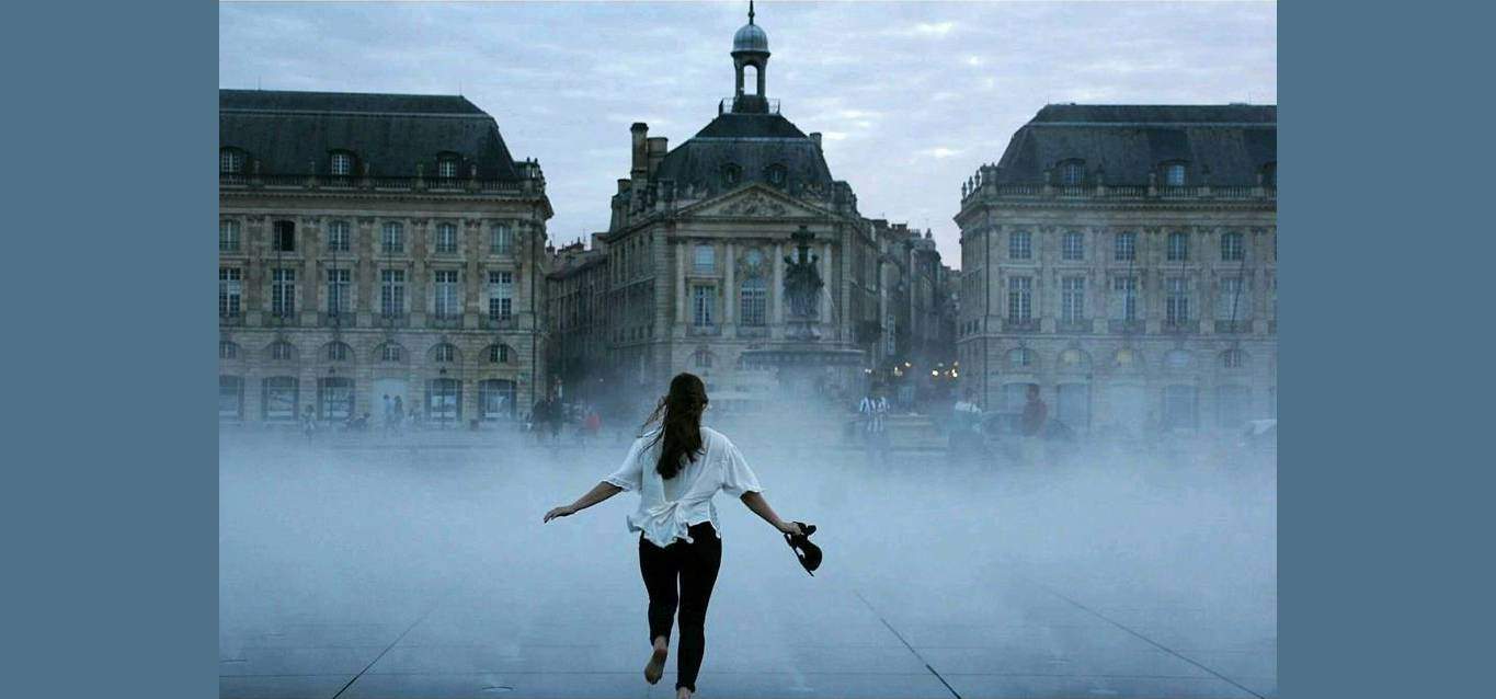 Woman running into fog outside Louvre museum