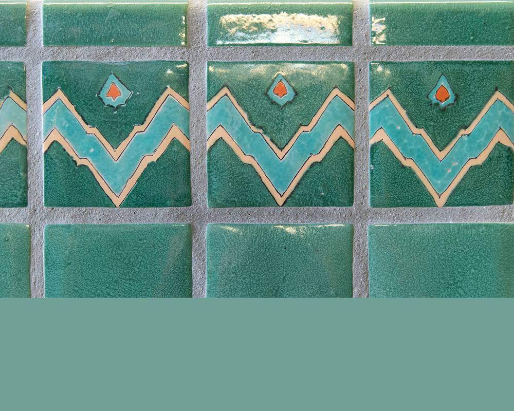 Geometrically-patterned tiles with stripe of teal color