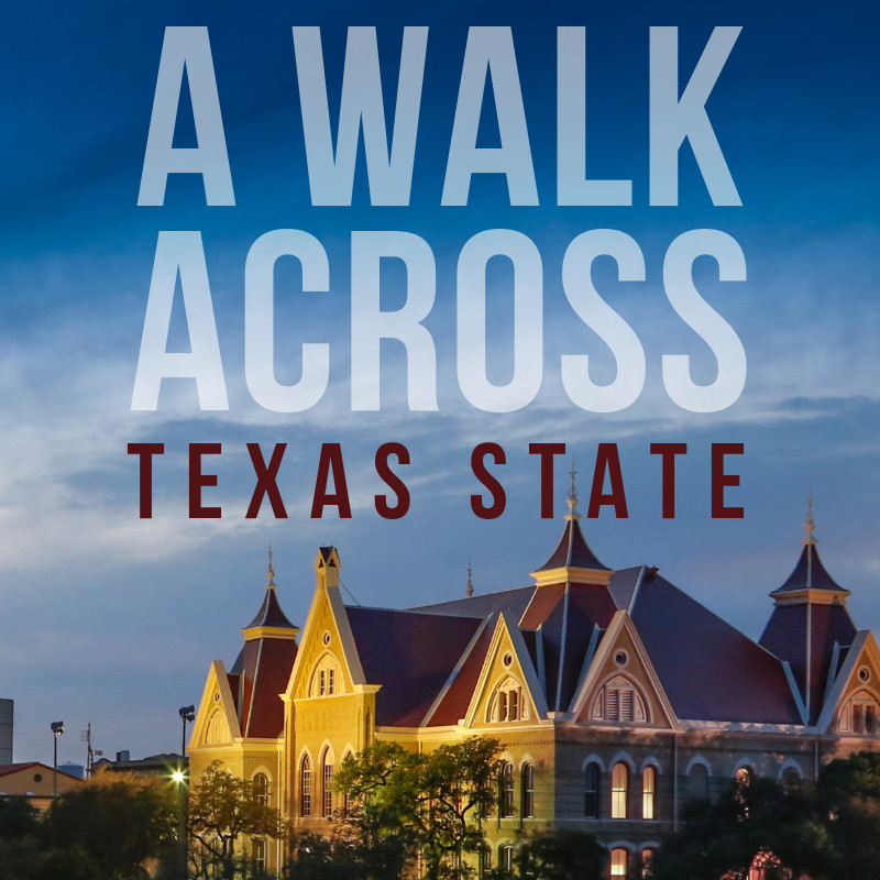 The words A Walk Across Texas State above Old Main at dusk