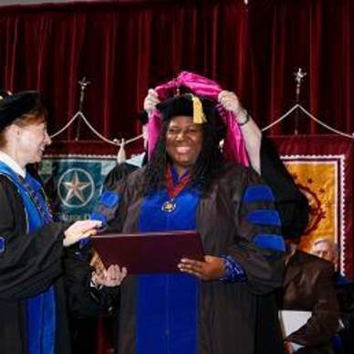 Doctoral candidate receives diploma from President Trauth 