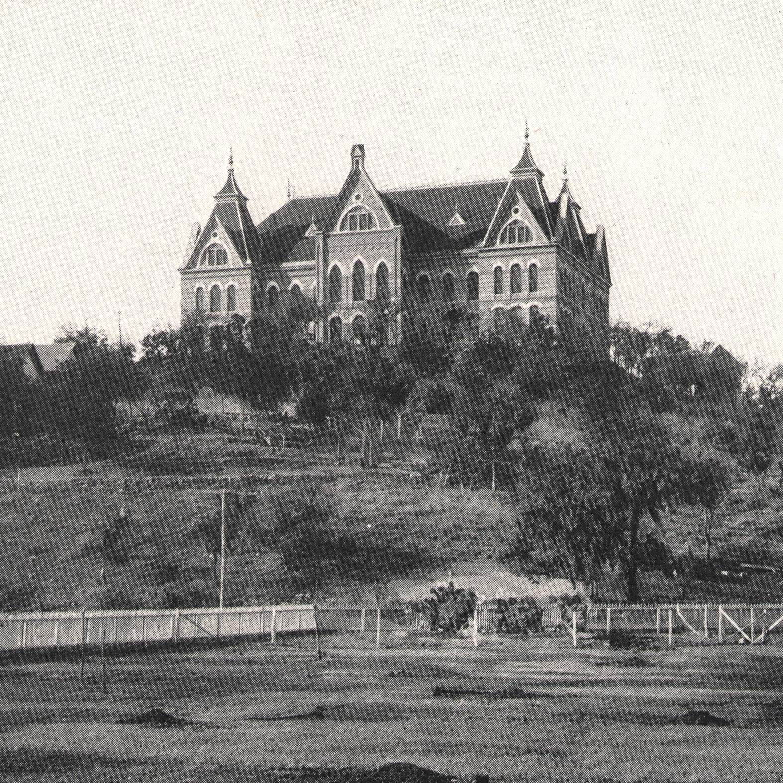 early 1900's image of Old Main at the top of the hill