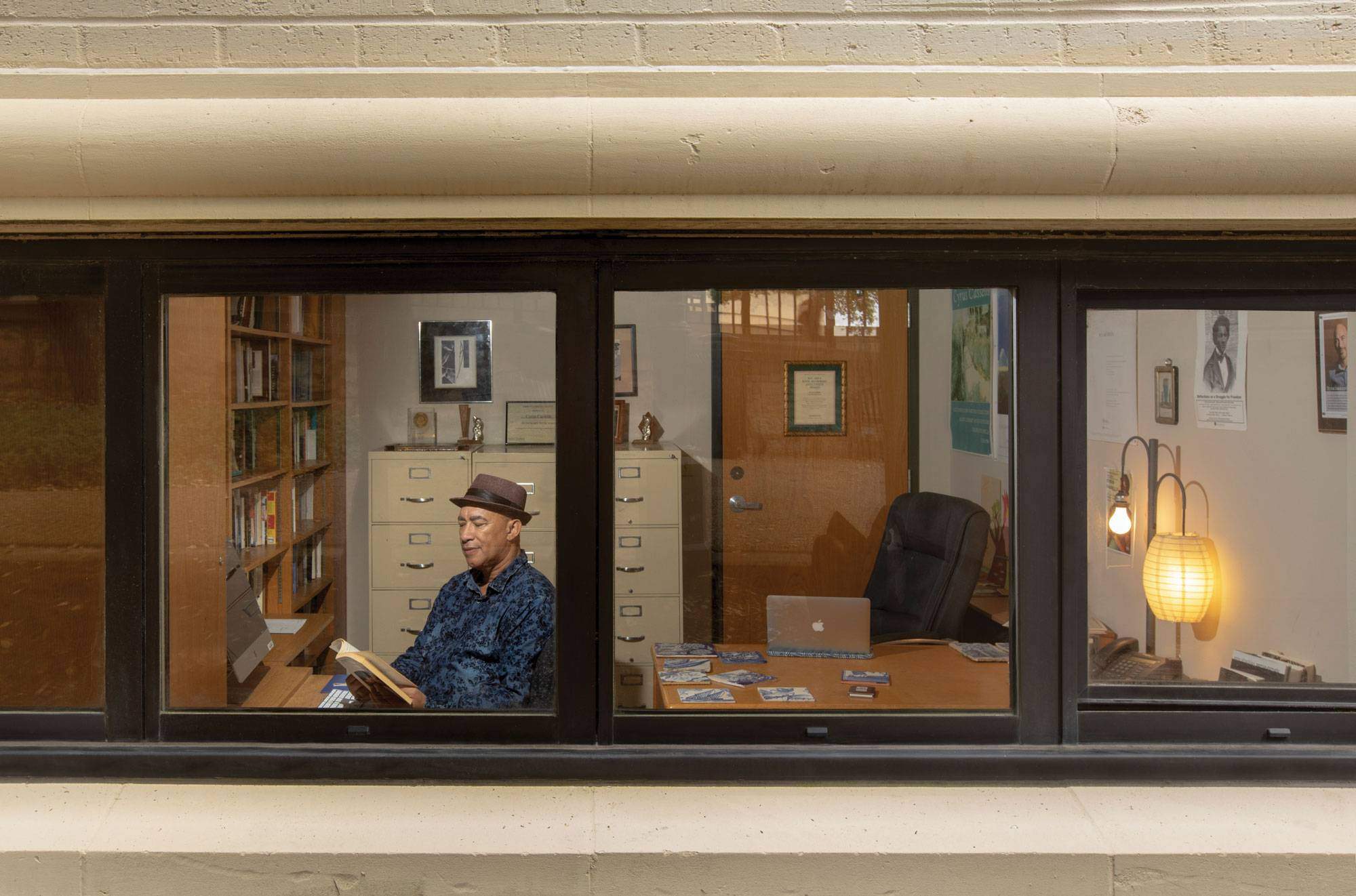 Cyrus Cassells through the window of his office