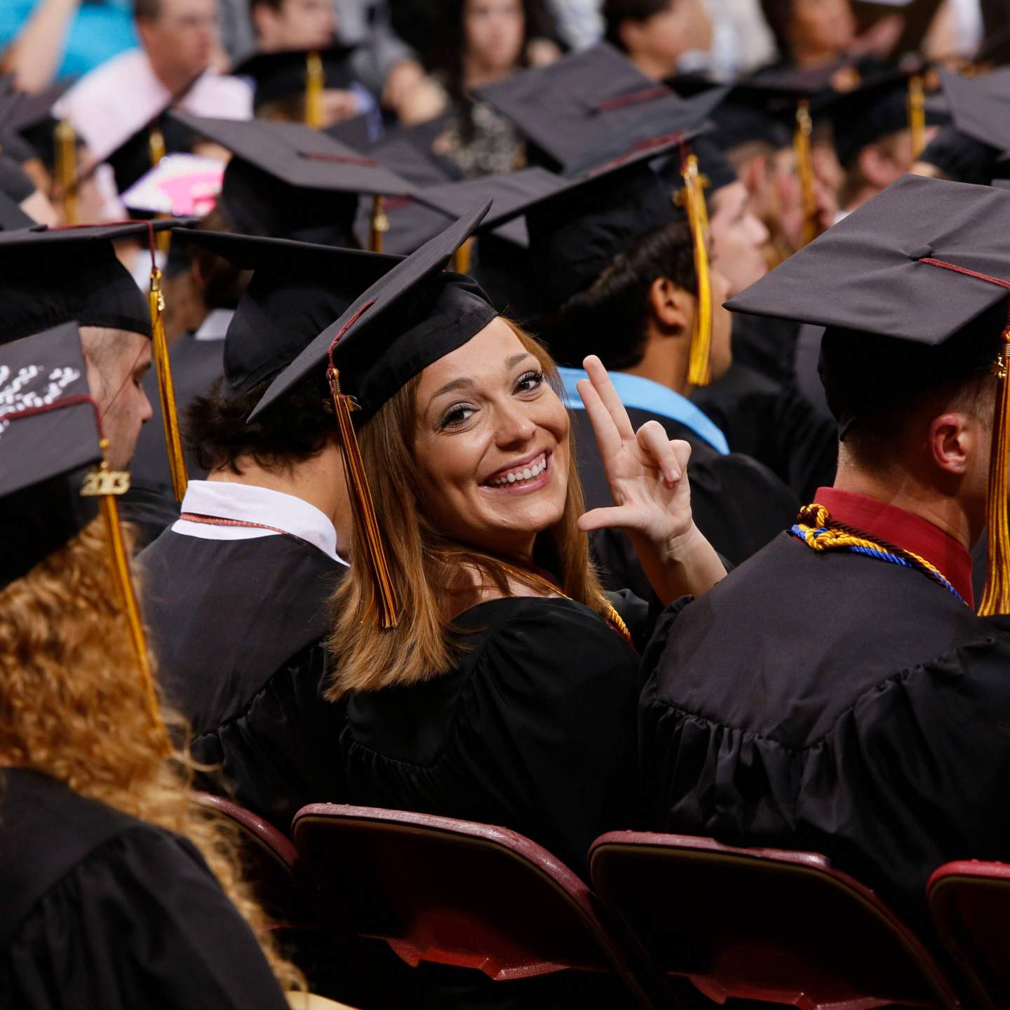Graduate doing "The Heart of Texas State Hand Sign"