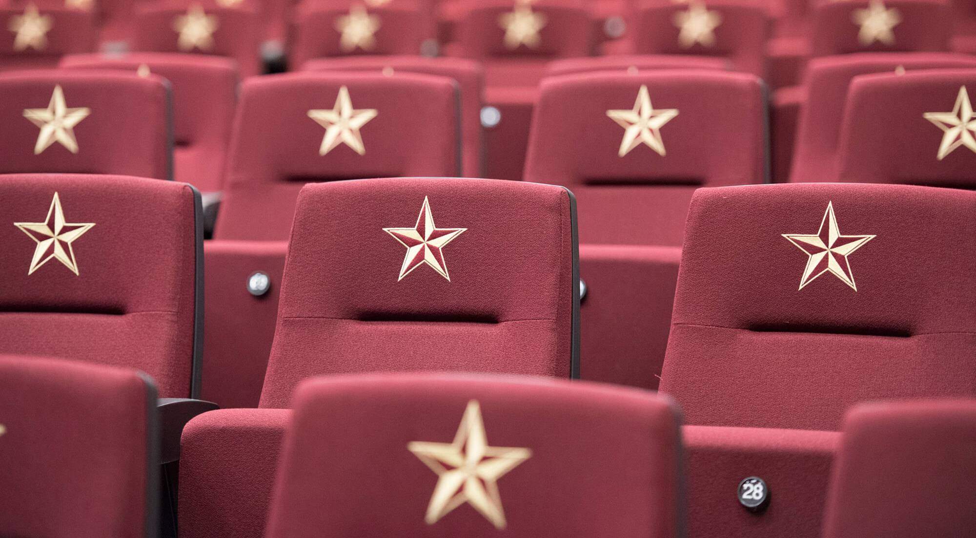 Maroon chairs with single gold star on each chair