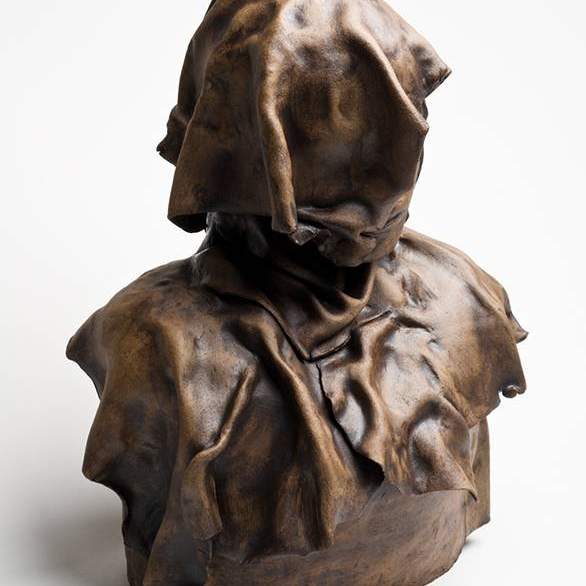 Student work: a bust with the face covered in a piece of fabric