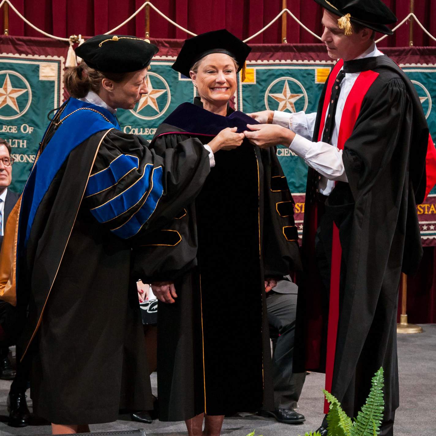 Mrs. Linda Fields Hooded by President Dr. Trauth and Provost Bourgeois