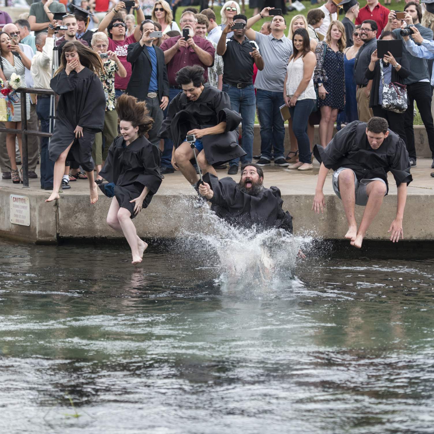 Graduates jumping into the river