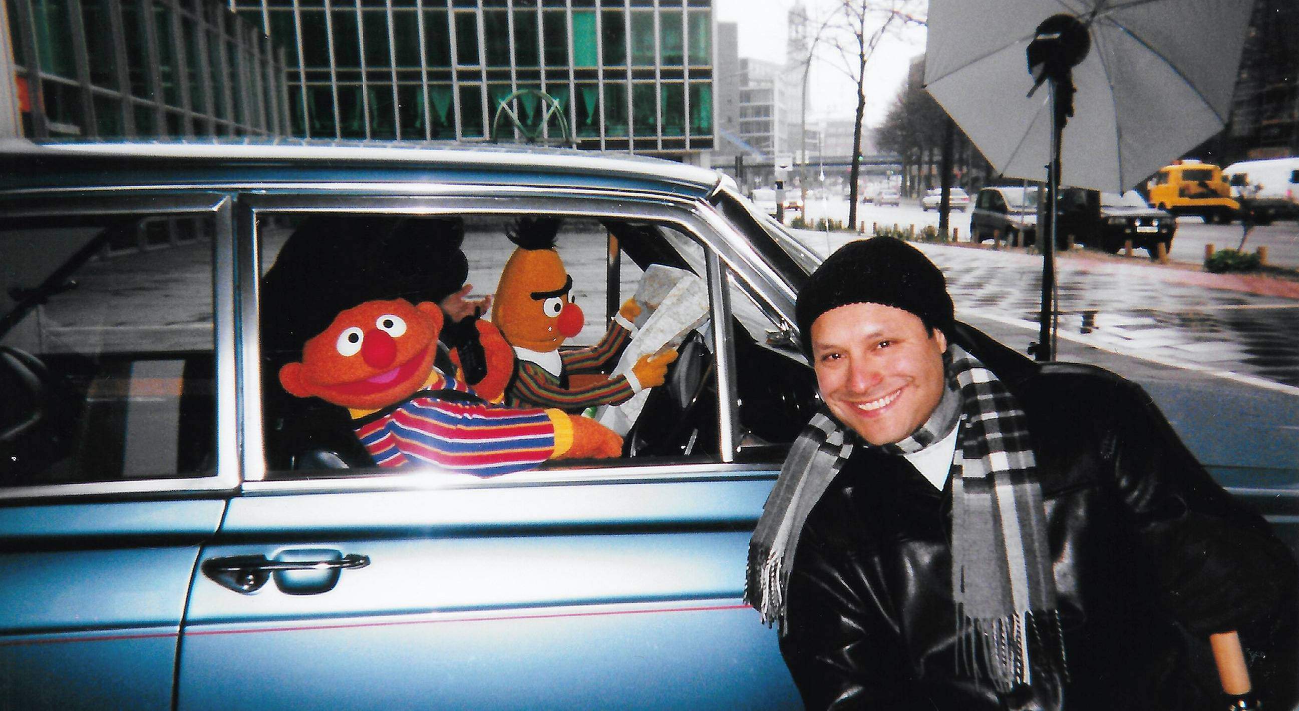 Estrada poses next to a car with Bert and Ernie from Sesame Street