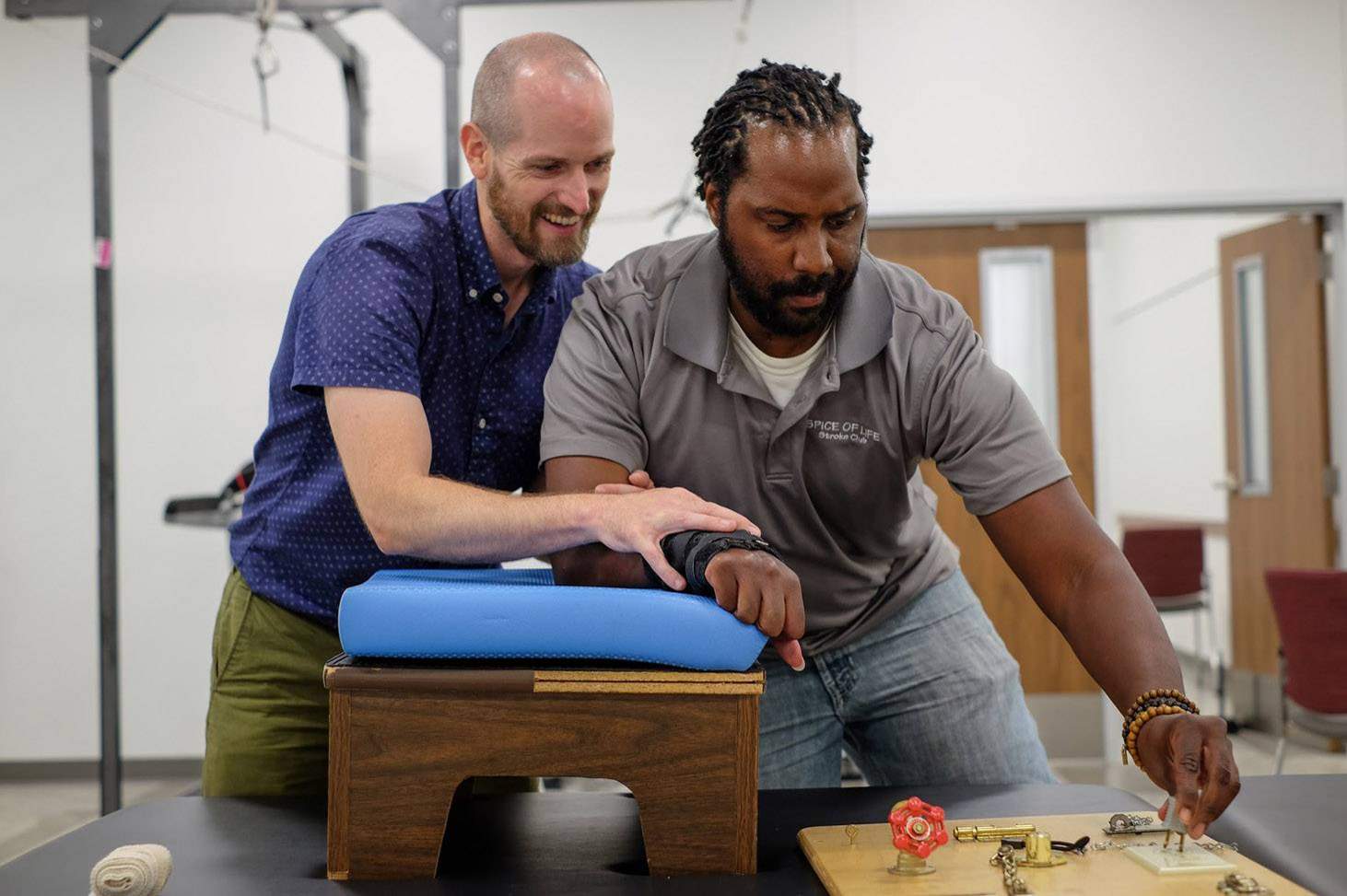 healthcare practitioner helping man with physical therapy 
