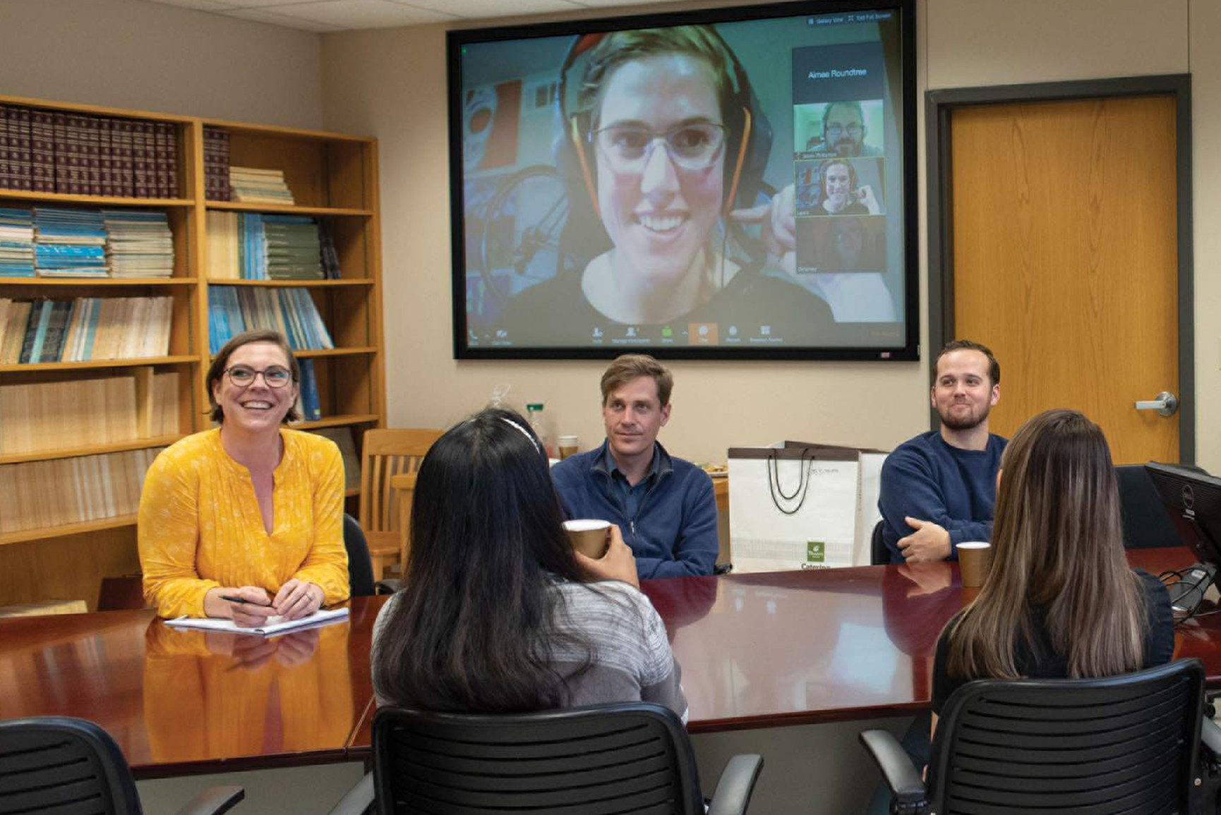 Students in conference room on a video call