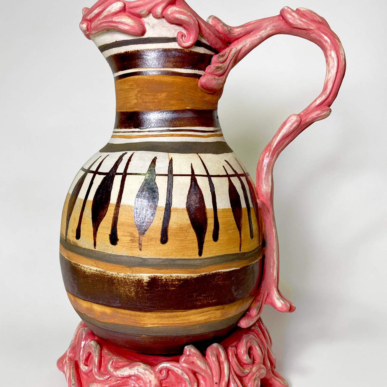 Student work: thrown pottery piece with biomorphic flowing forms for the handle, lip and base