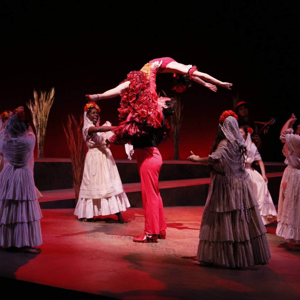 Man lifting flamenco dancer in the air