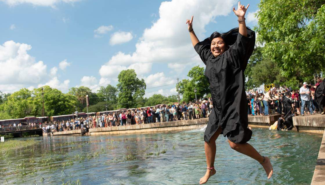 graduate jumping into the river