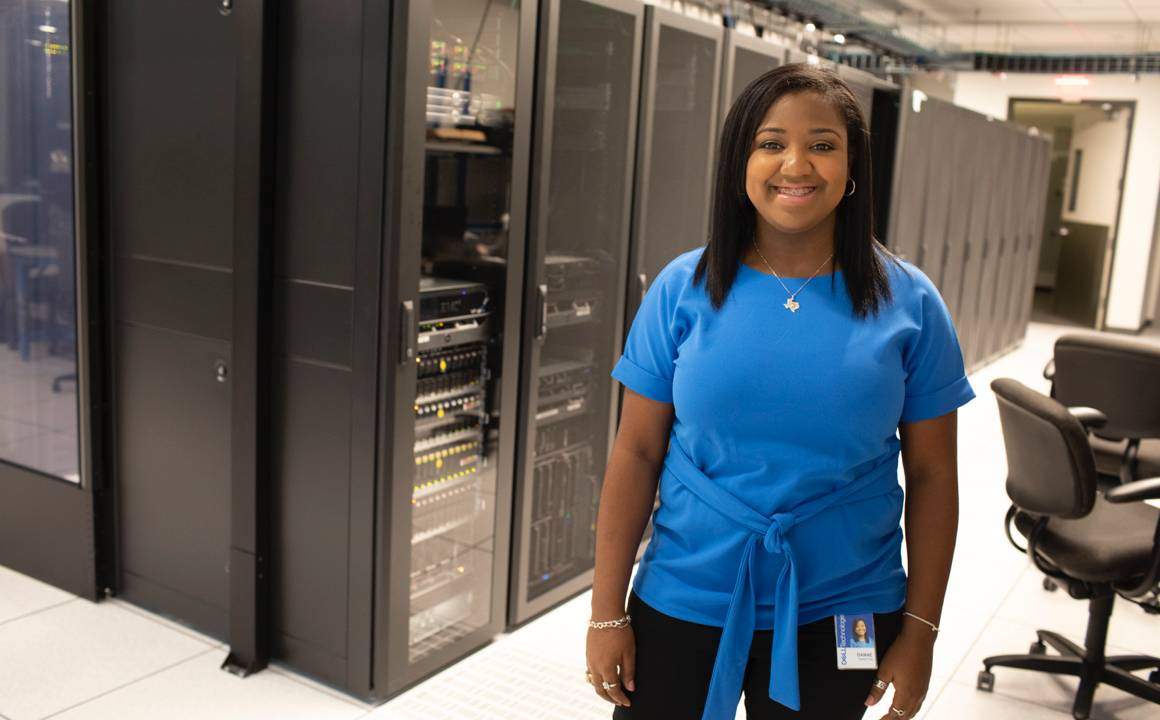 Danae Winston standing in front Dell servers