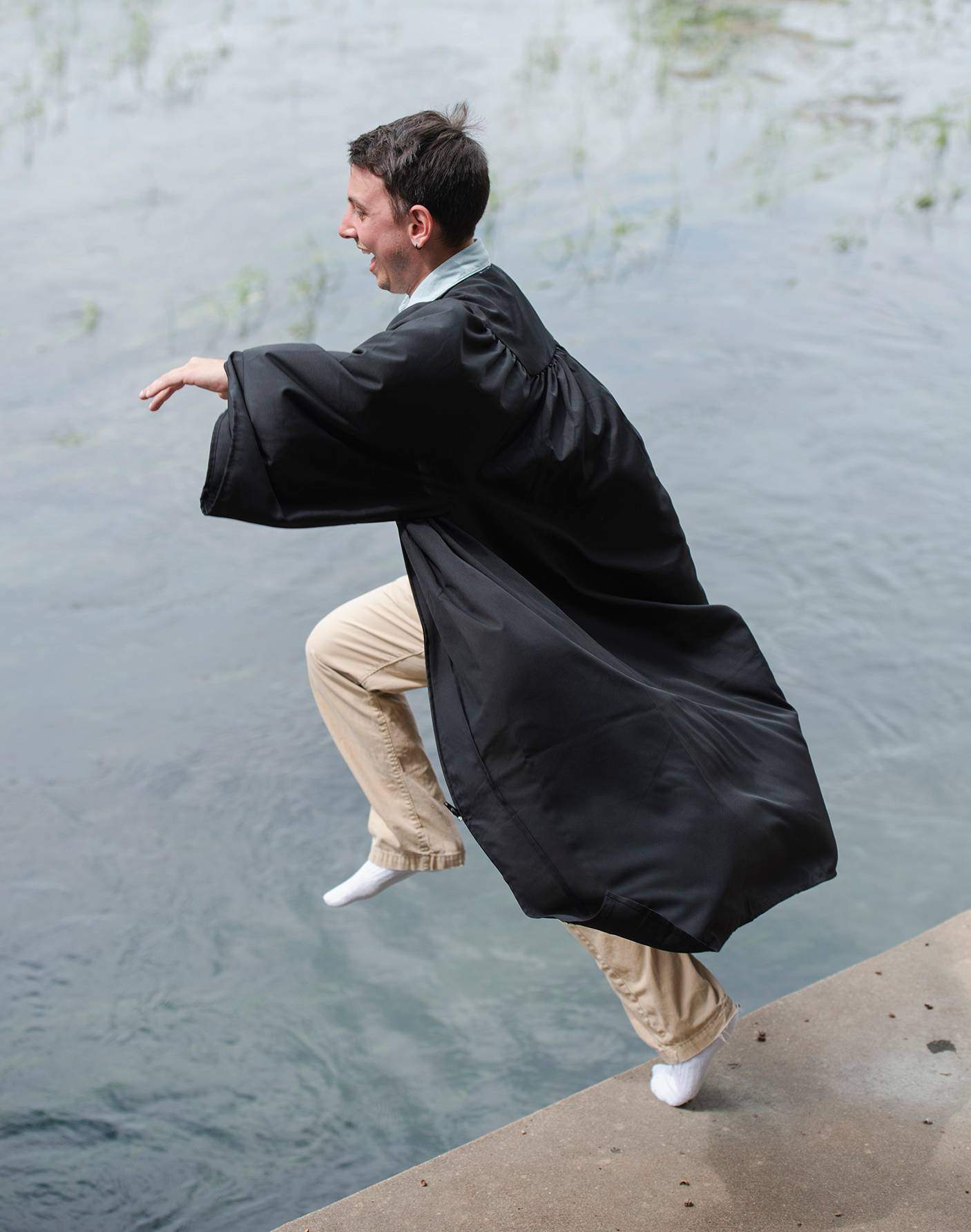 man jumping in river