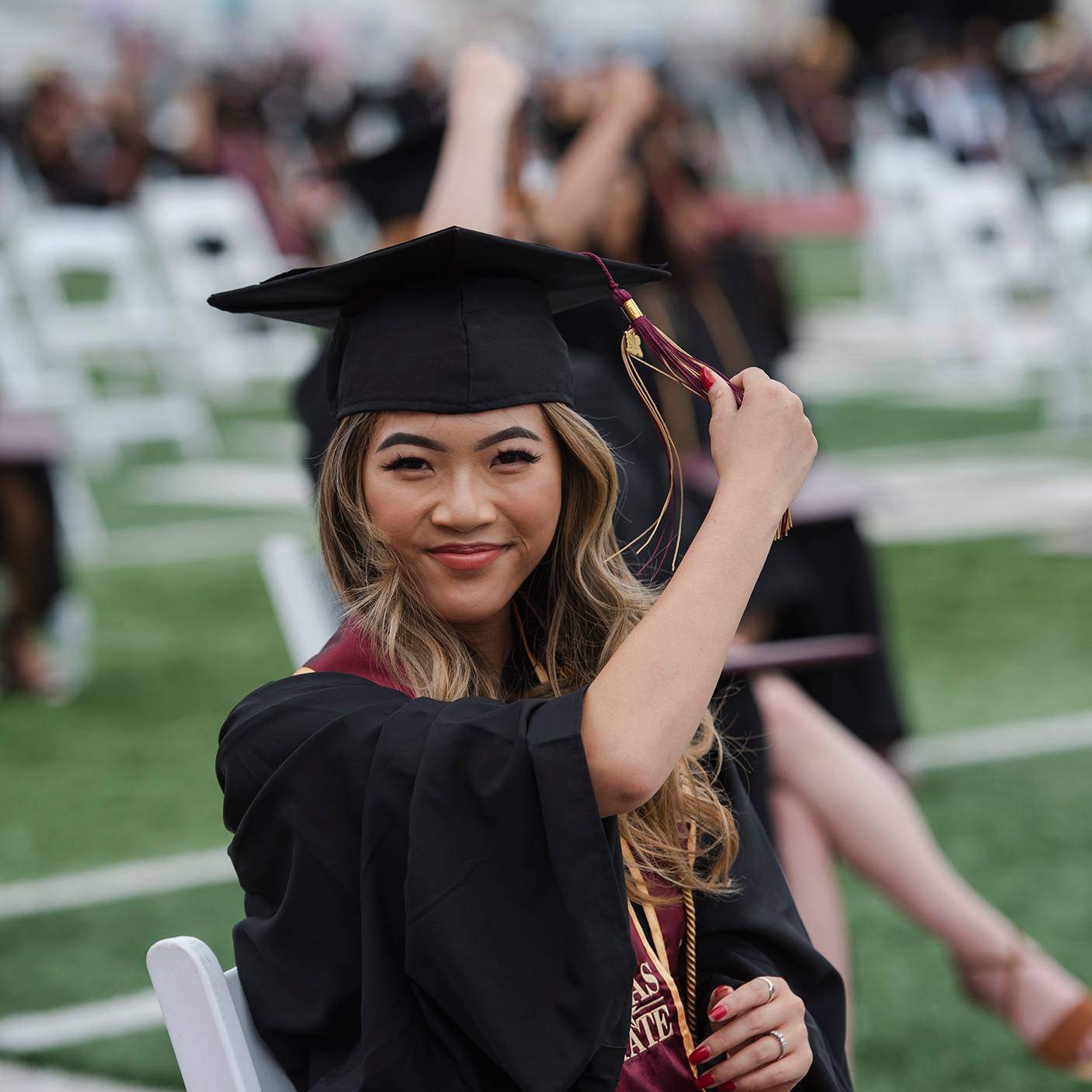 female graduate turning hat